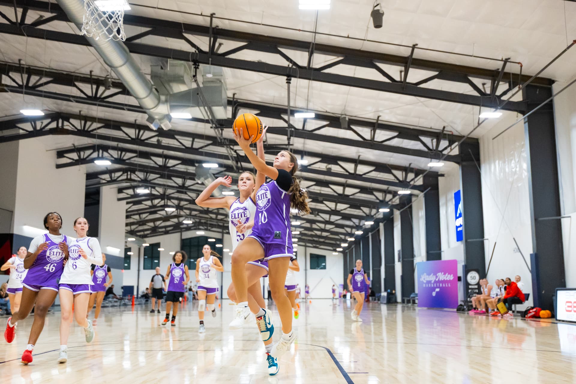 Lady Notes girls basketball action — competing on the court