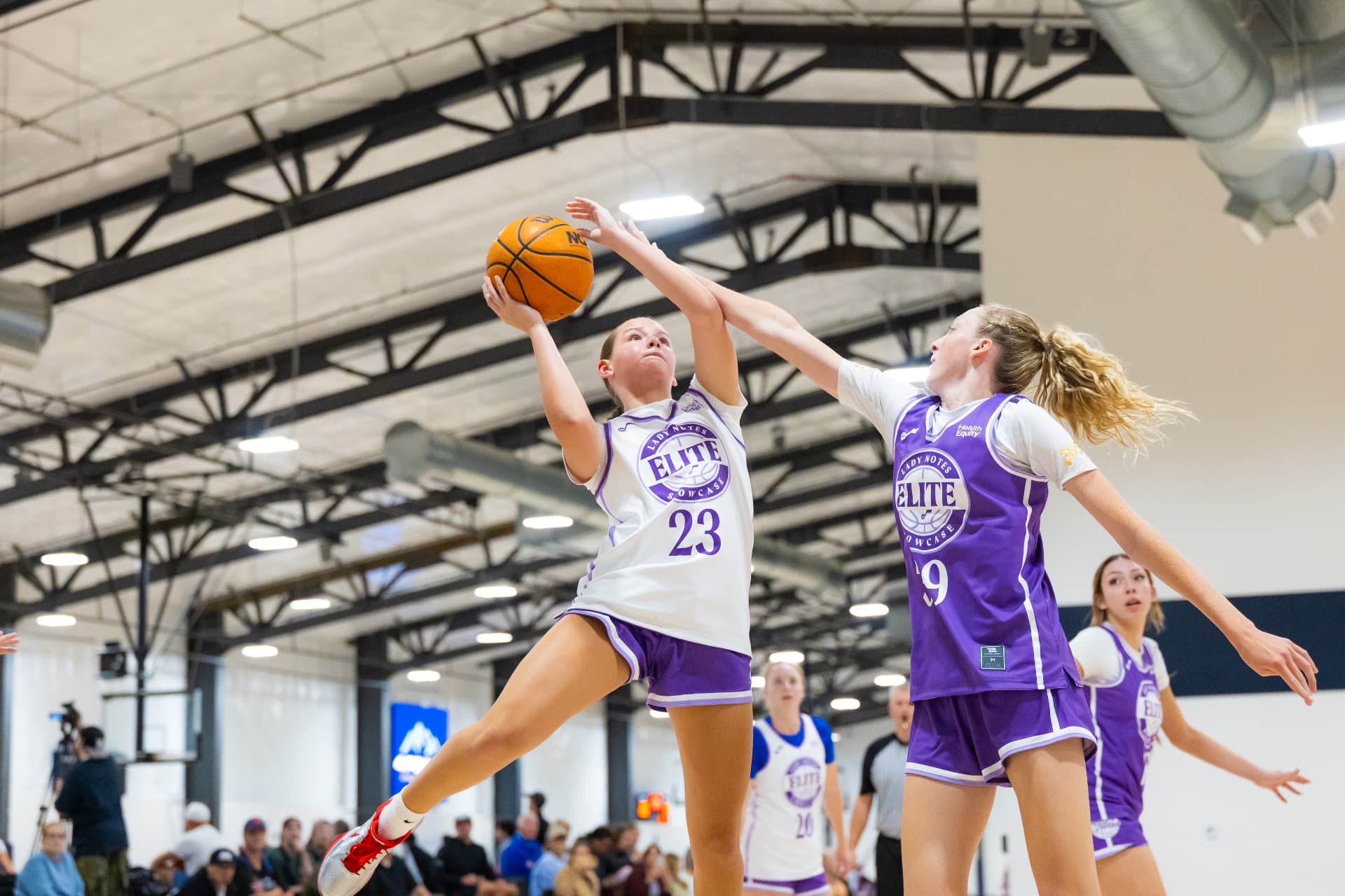 Girls basketball game action from a Lady Notes Showcase event